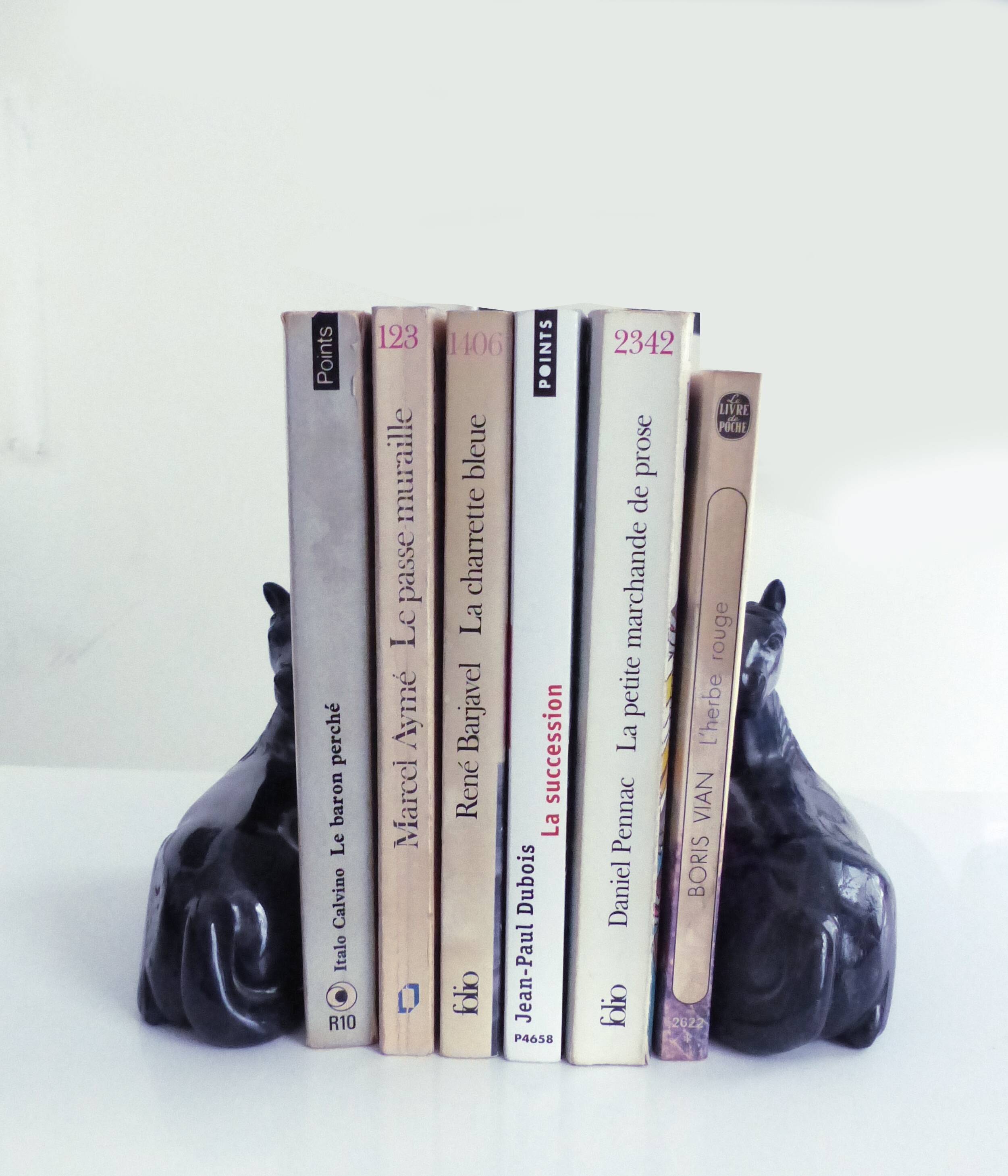 Black marble bookends with lying horses
