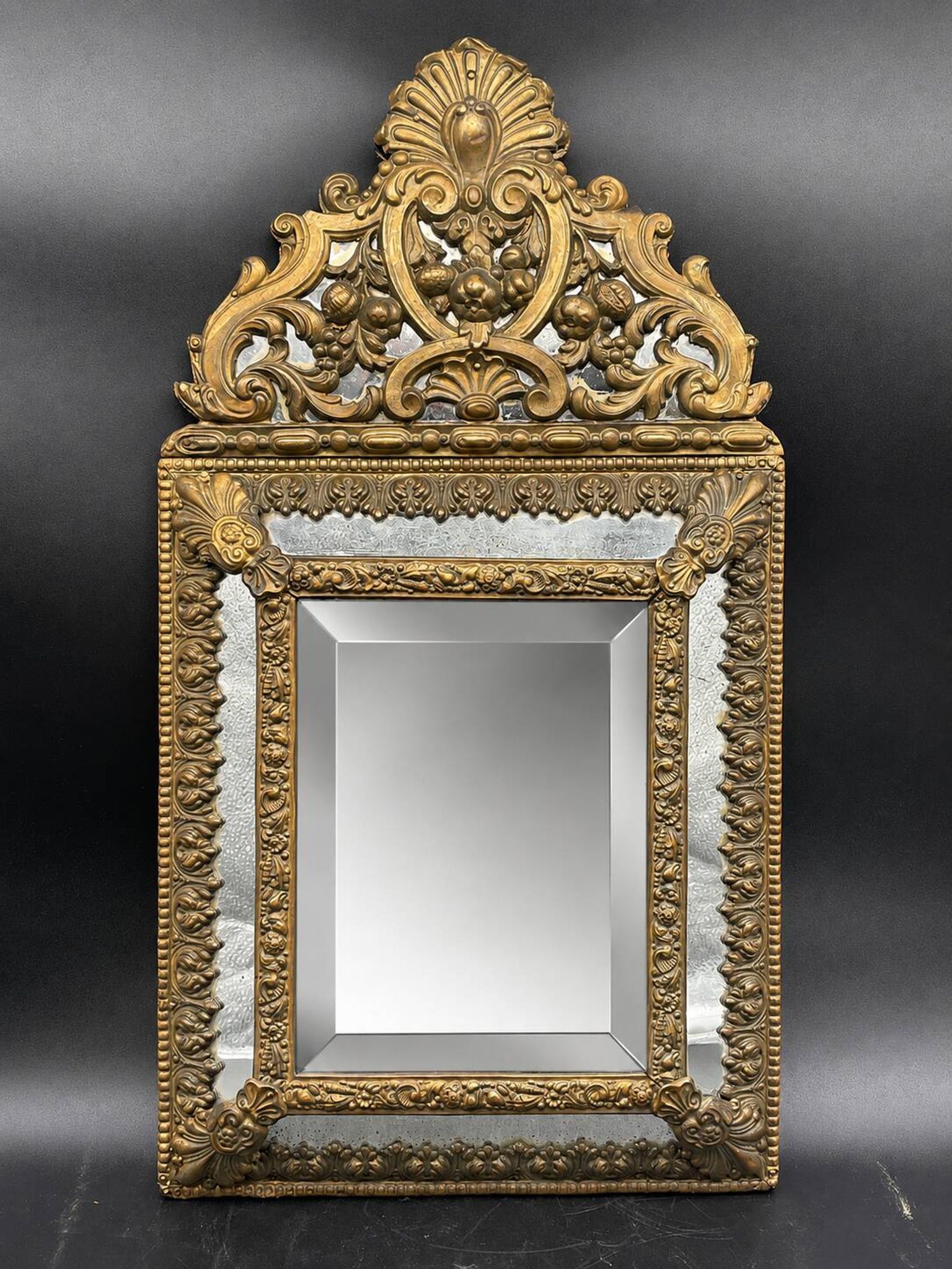 Small mirror with brass parcloses in repoussé style Louis XIV, late 19th century.