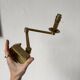Pair of brass wall lights with articulated arms from the 70s
