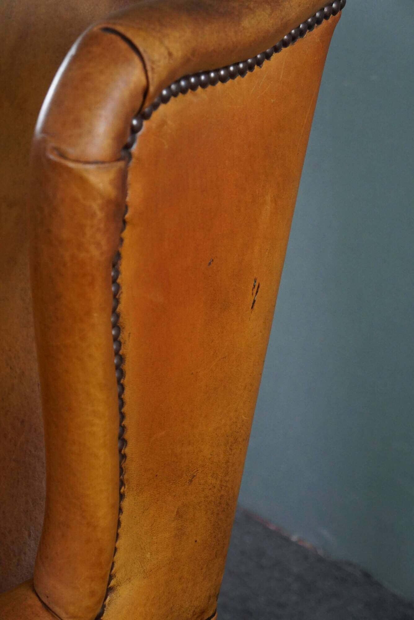 Wingback chair made of sheepskin leather in a light honey color