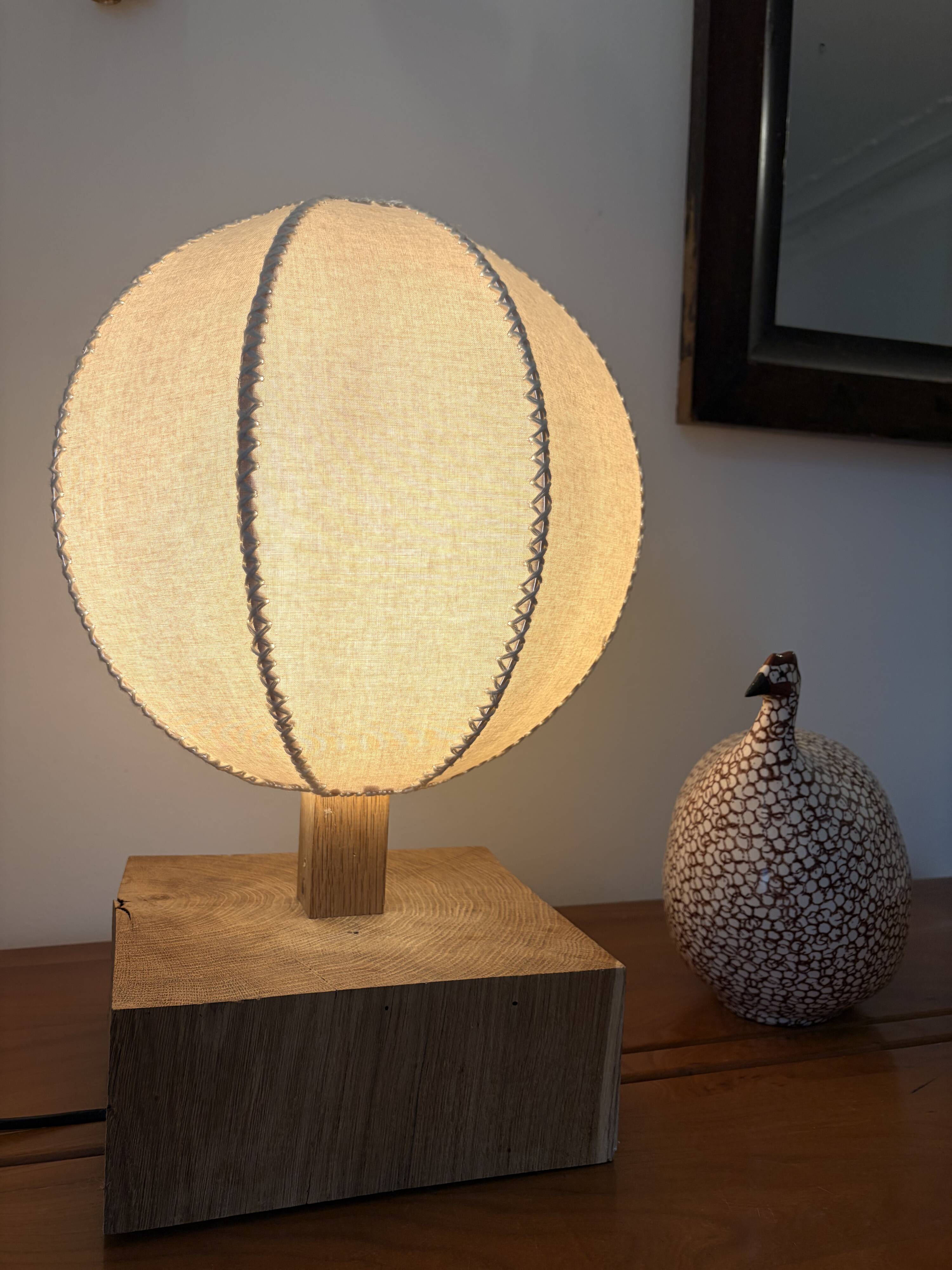 Handmade wooden ball lamp on a stand