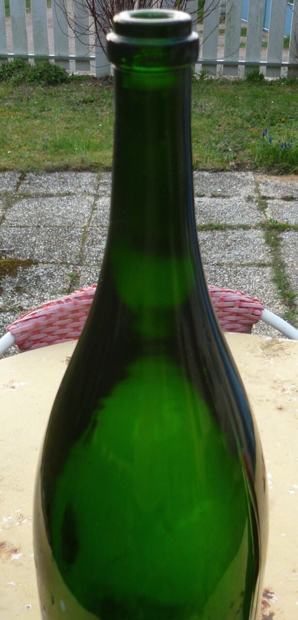 Green blown glass bottle of 58 cm.