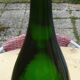 Green blown glass bottle of 58 cm.