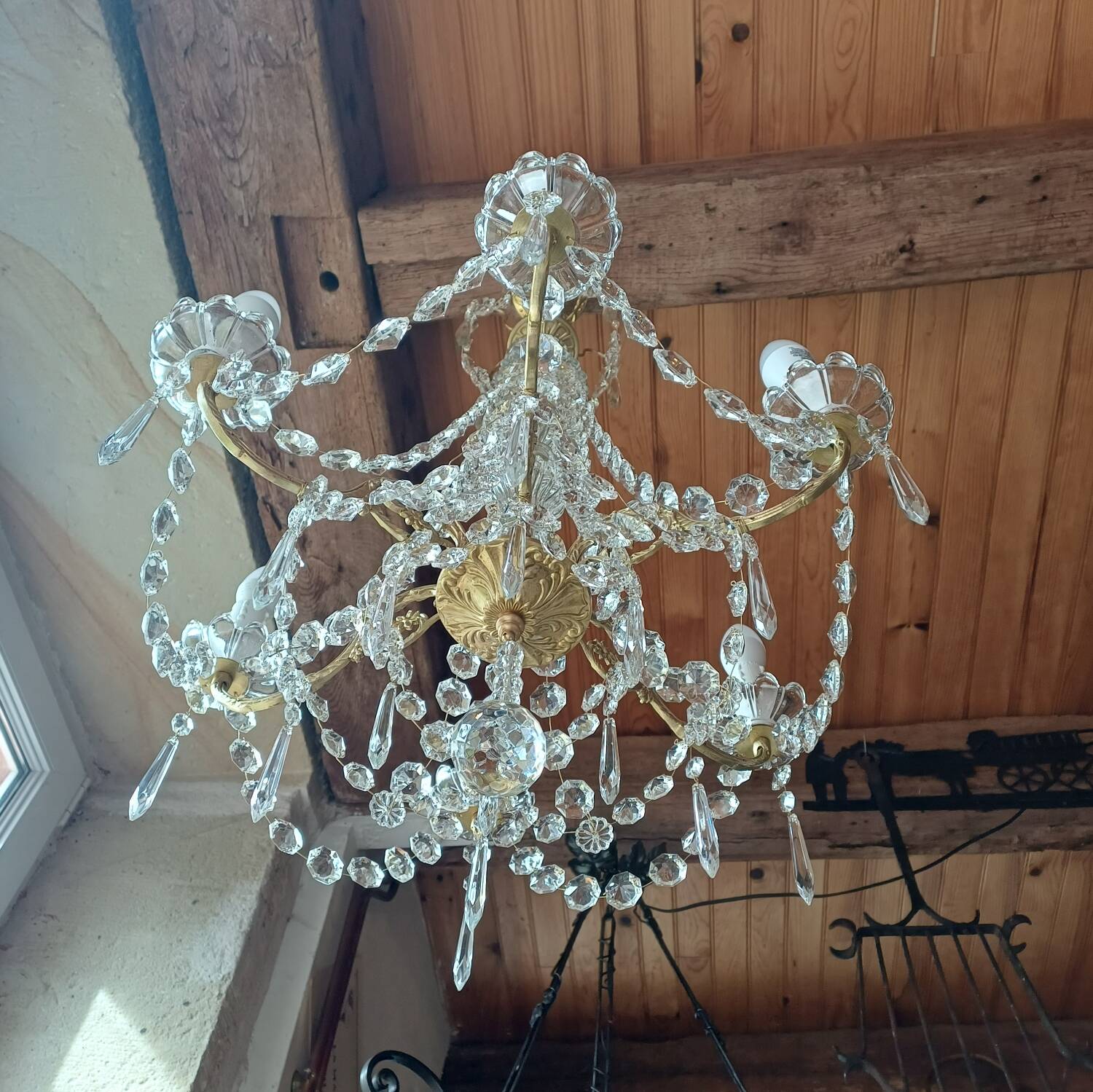 Antique chandelier with pendants in bronze and crystal.