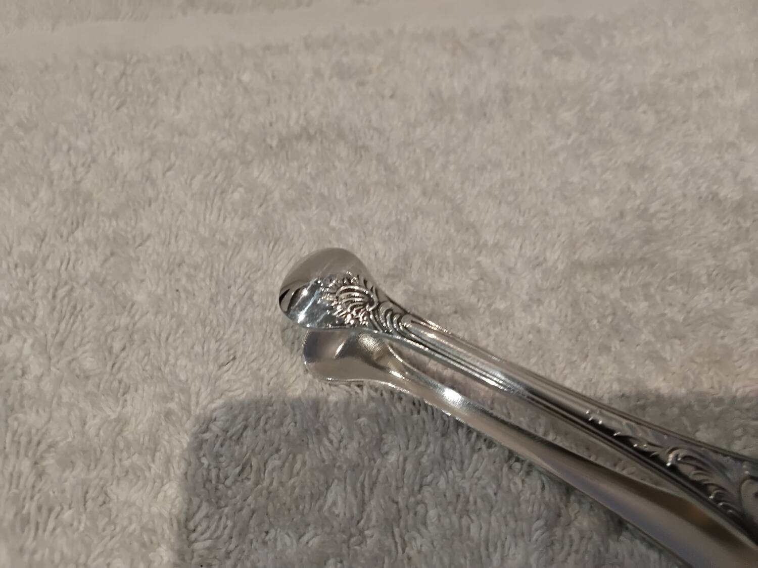 Small silver-plated sugar tongs by Christofle Marly, 11.3 cm