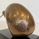Bronze sculpture representing a stylised bird on a black marble base, signed and numbered.