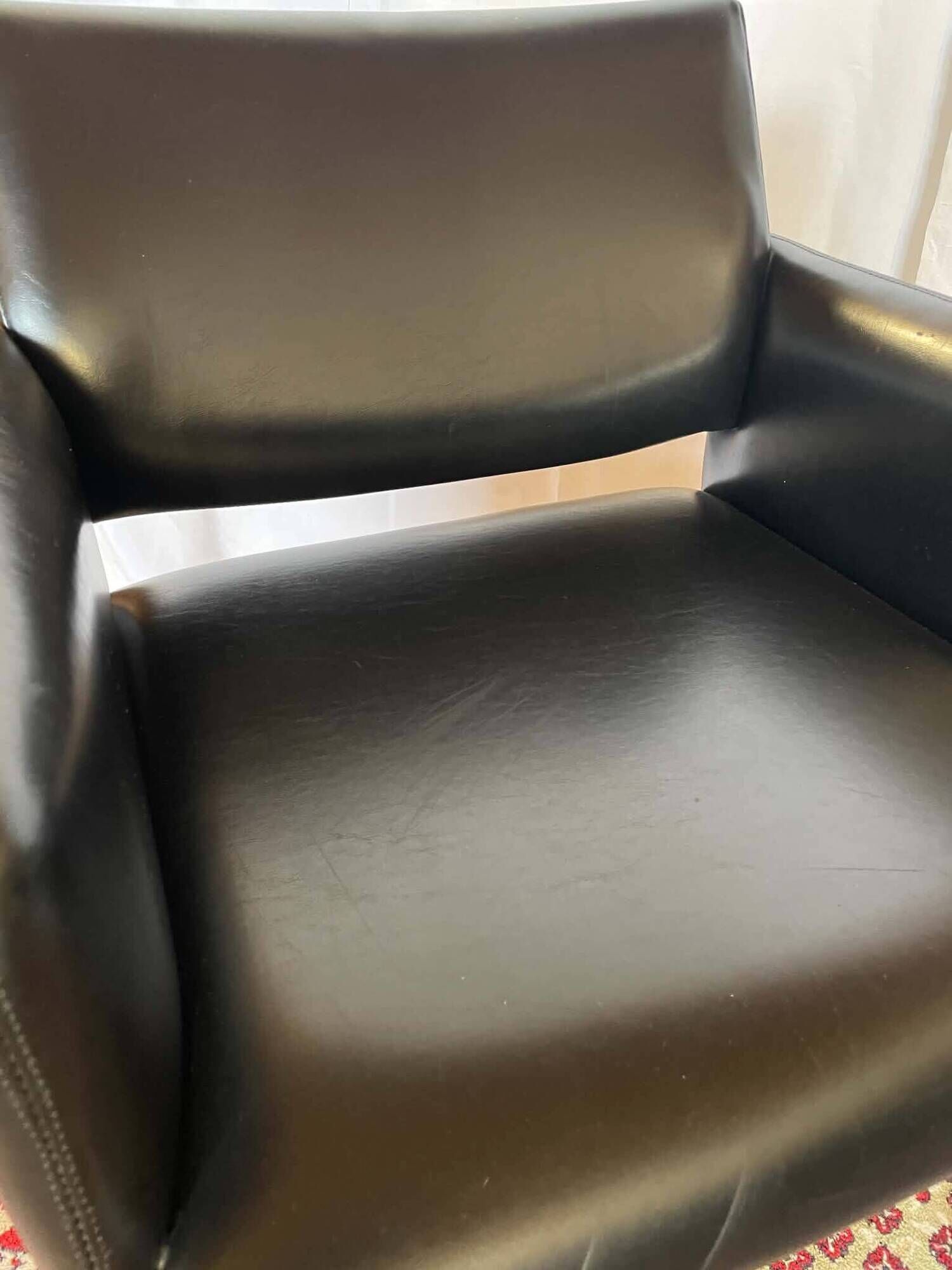 Pair of vintage armchairs in black faux leather and chrome metal.