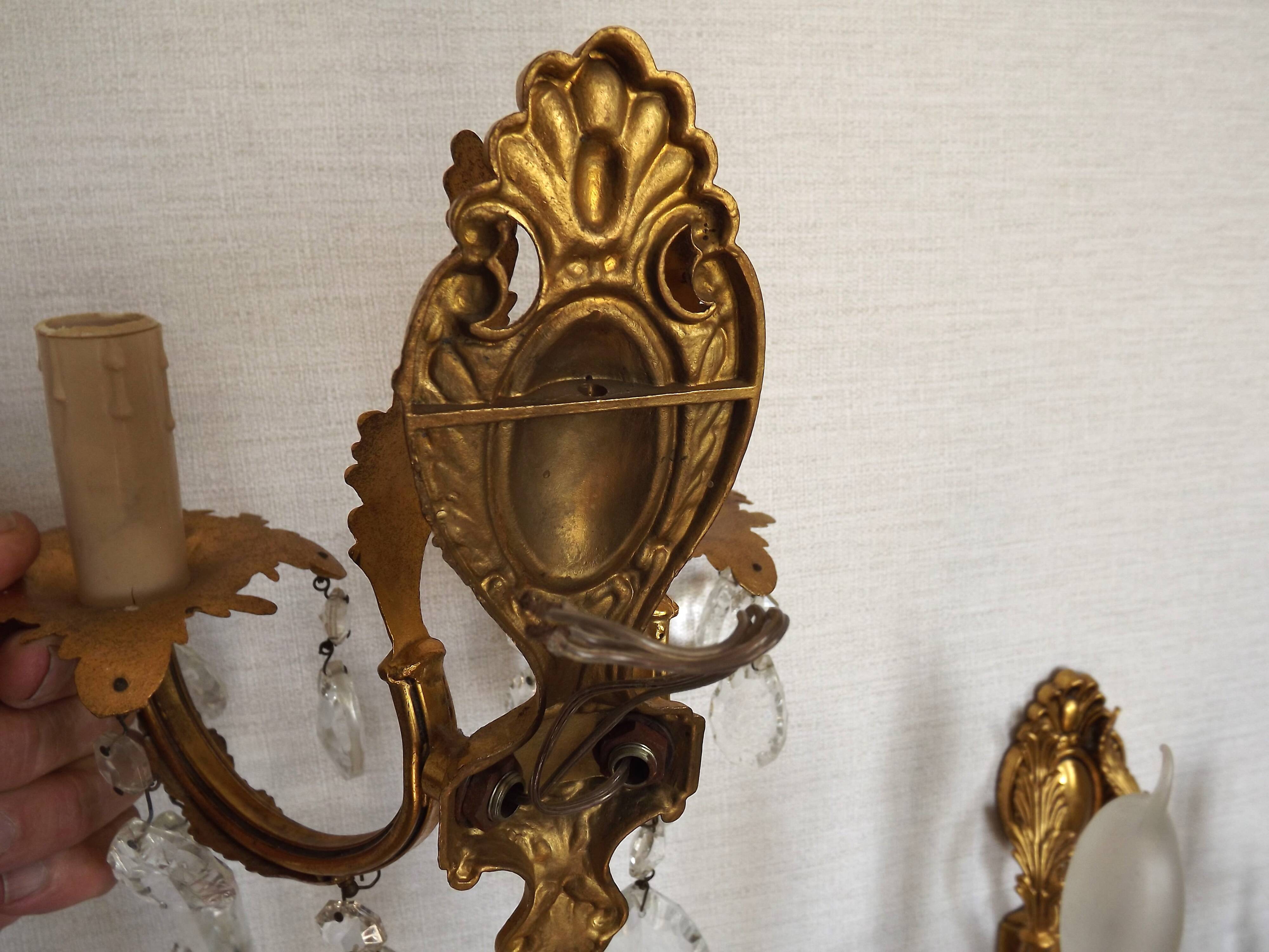 Pair of antique 2-light wall sconces in bronze with crystal pendants, Spain.