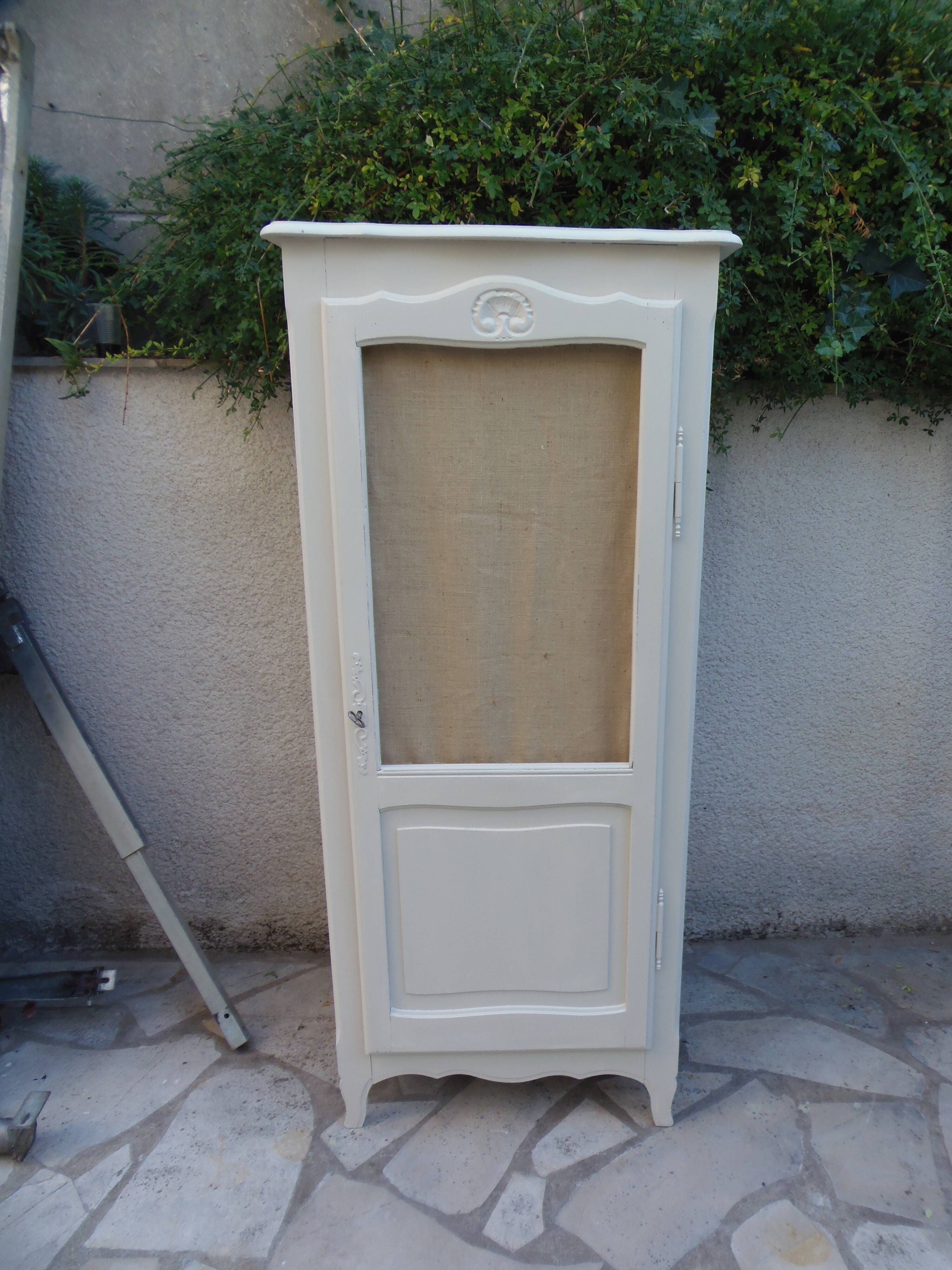 Vintage beige wardrobe made of wood and jute fabric.