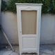 Vintage beige wardrobe made of wood and jute fabric.