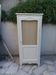 Vintage beige wardrobe made of wood and jute fabric.