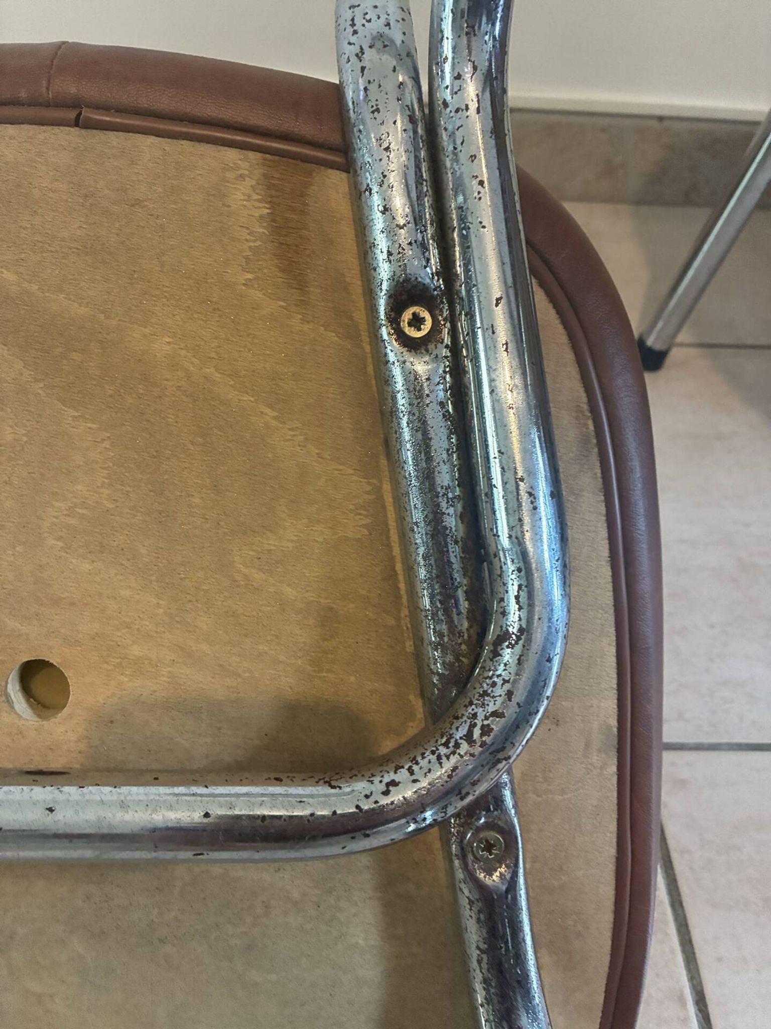 Two brown faux leather chairs.