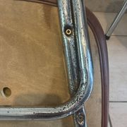 Two brown faux leather chairs.