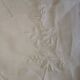 Antique embroidered linen sheet with a monogram.