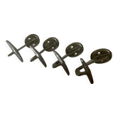 Four old cast aluminum coat hooks