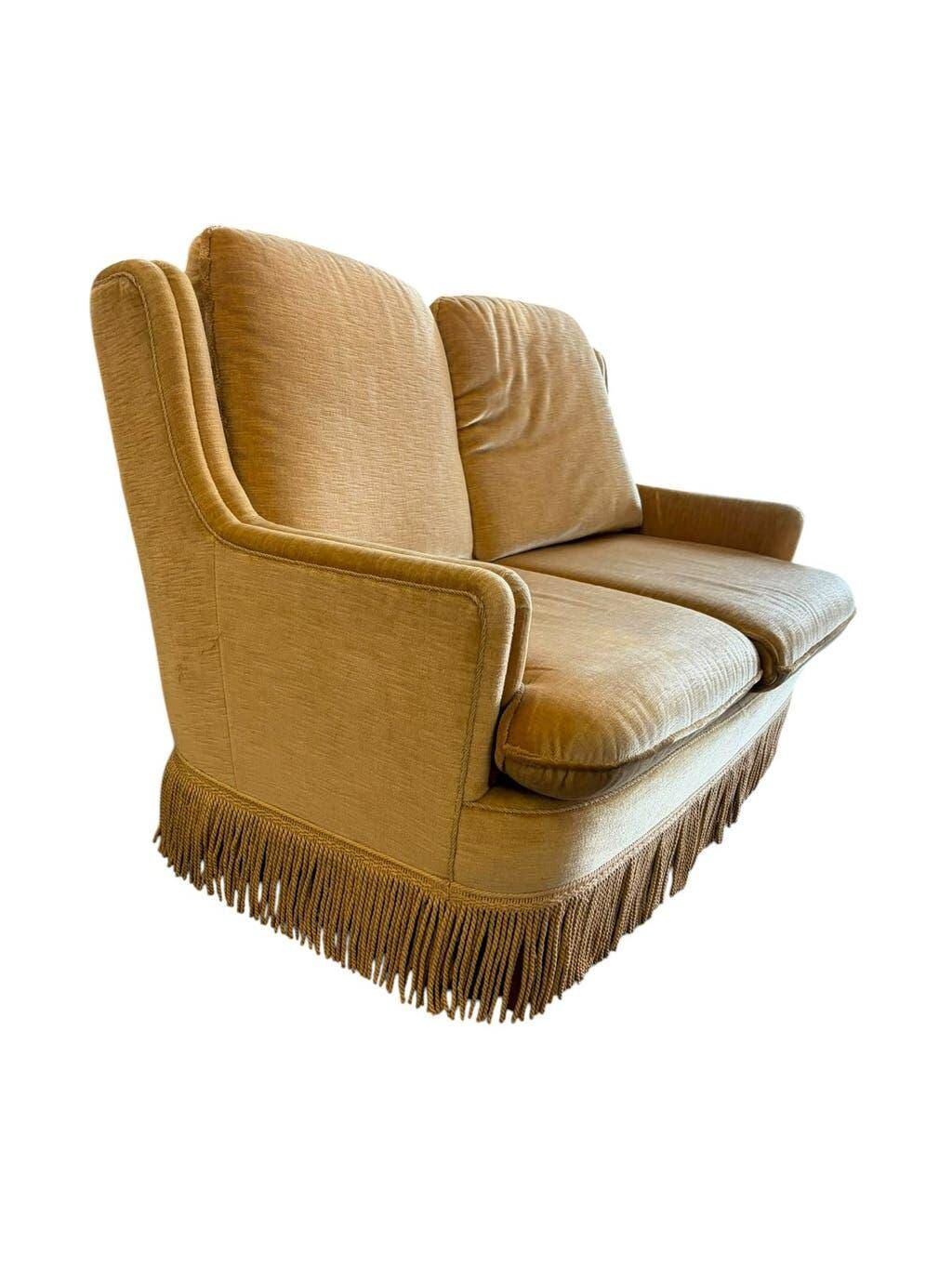 Vintage beige two-seater sofa with fringes