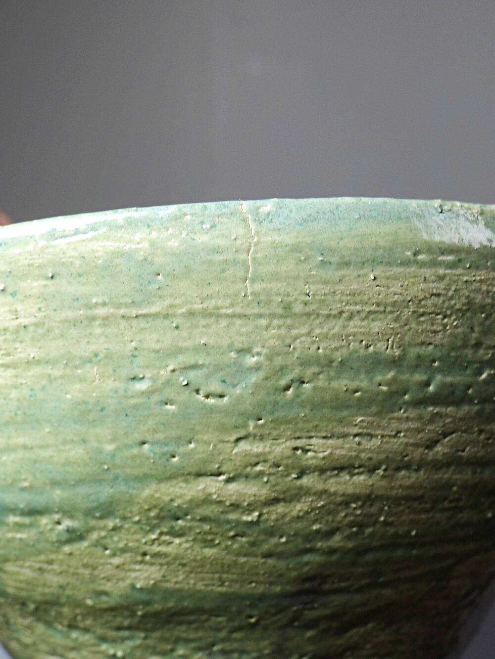 Wabi-Sabi handcrafted ceramic bowl in celadon green, 20th-19th century.