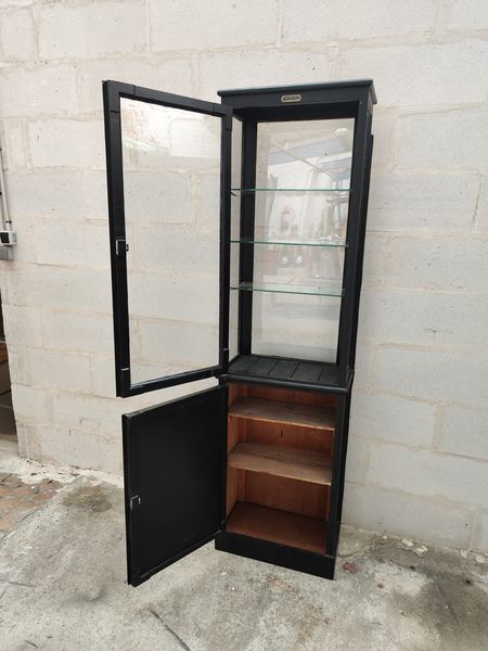 Old wooden window of black patina store two doors