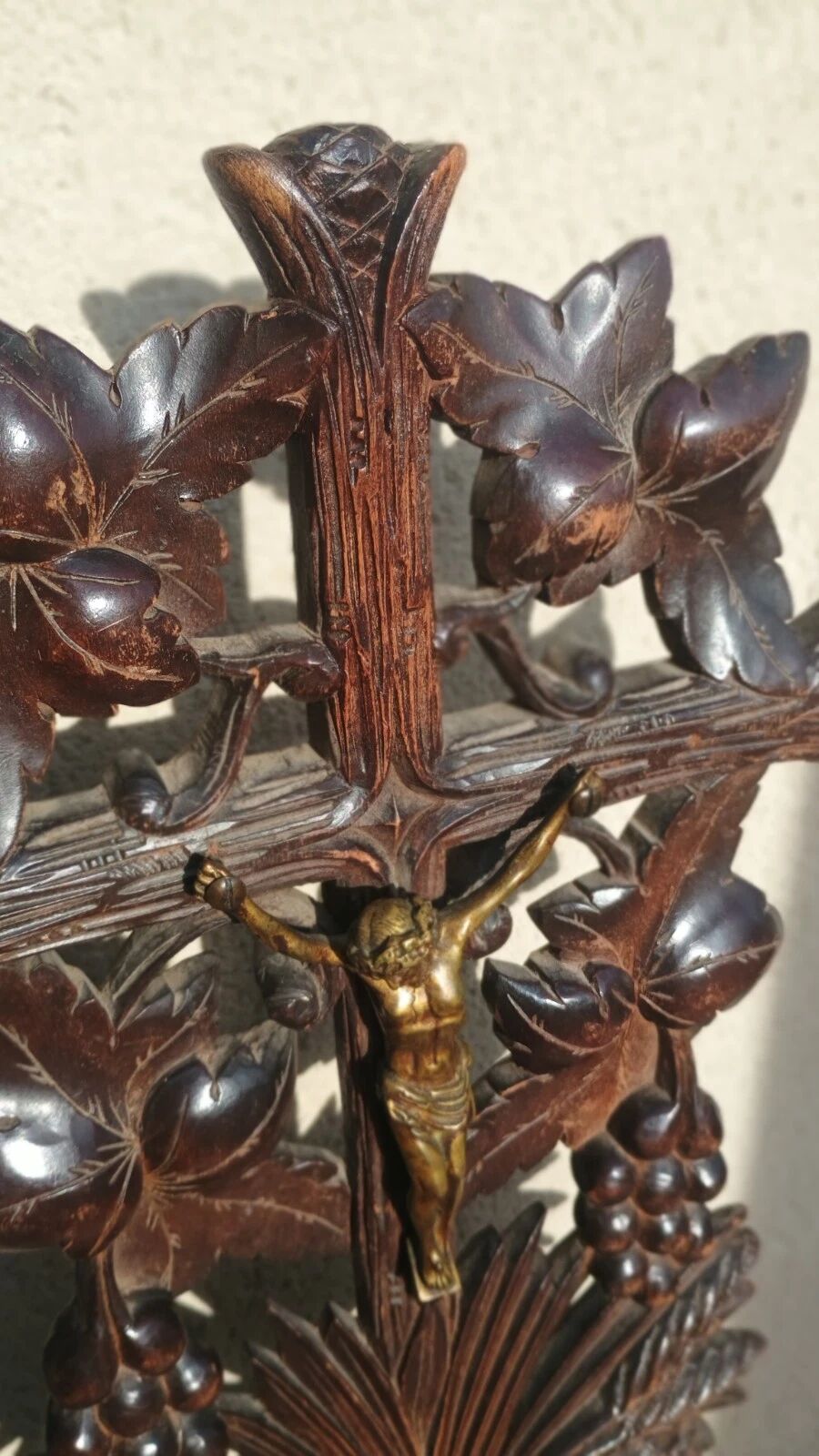 Antique wooden crucifix carved from the Black Forest with grapes and leaves.