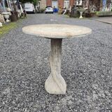 Cement garden table with trunk-shaped foot
