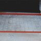 Single bed with wooden headboard and footboard and metal box spring