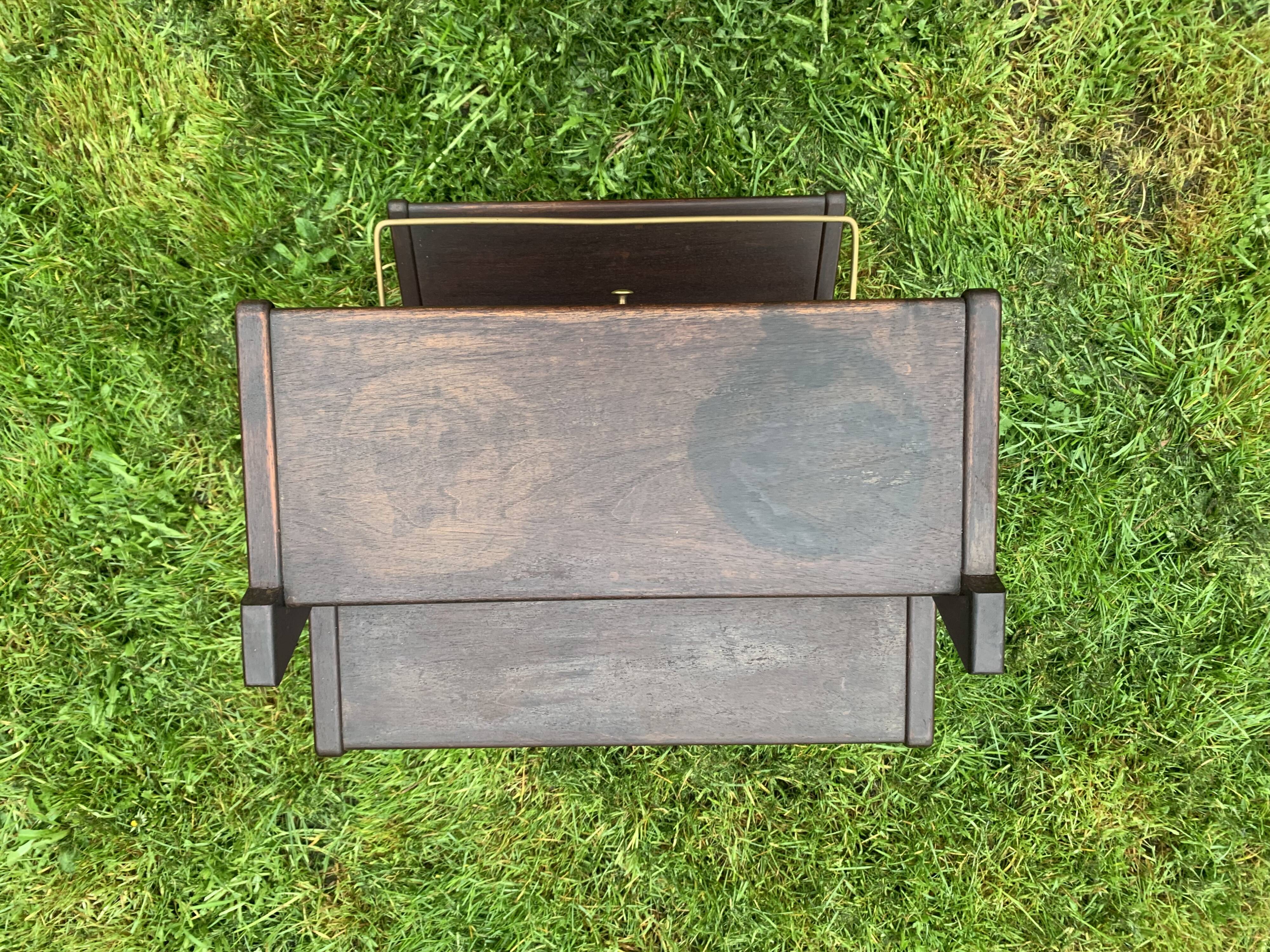 Old Scandinavian style magazine rack in dark wood with integrated brass ashtray