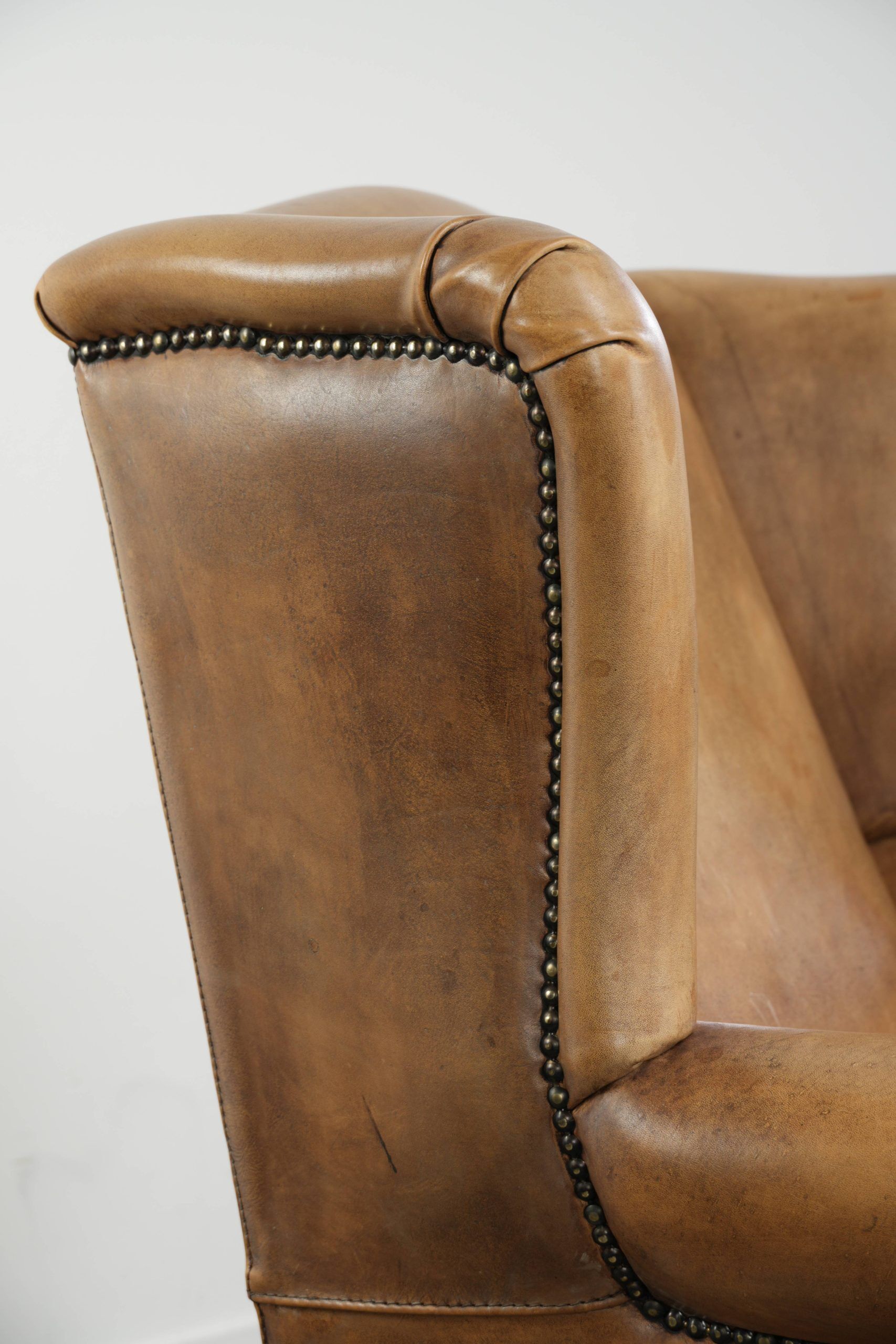 Comfortable cowhide wingback armchair with a timeless English look