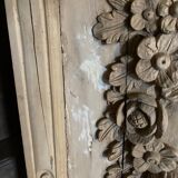 wooden painting with carved floral motif - note a restoration on the left side at the bottom.