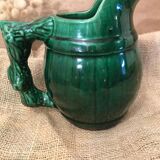 Porcelain pitcher in the shape of a barrel, with its handle that looks like a vine stock