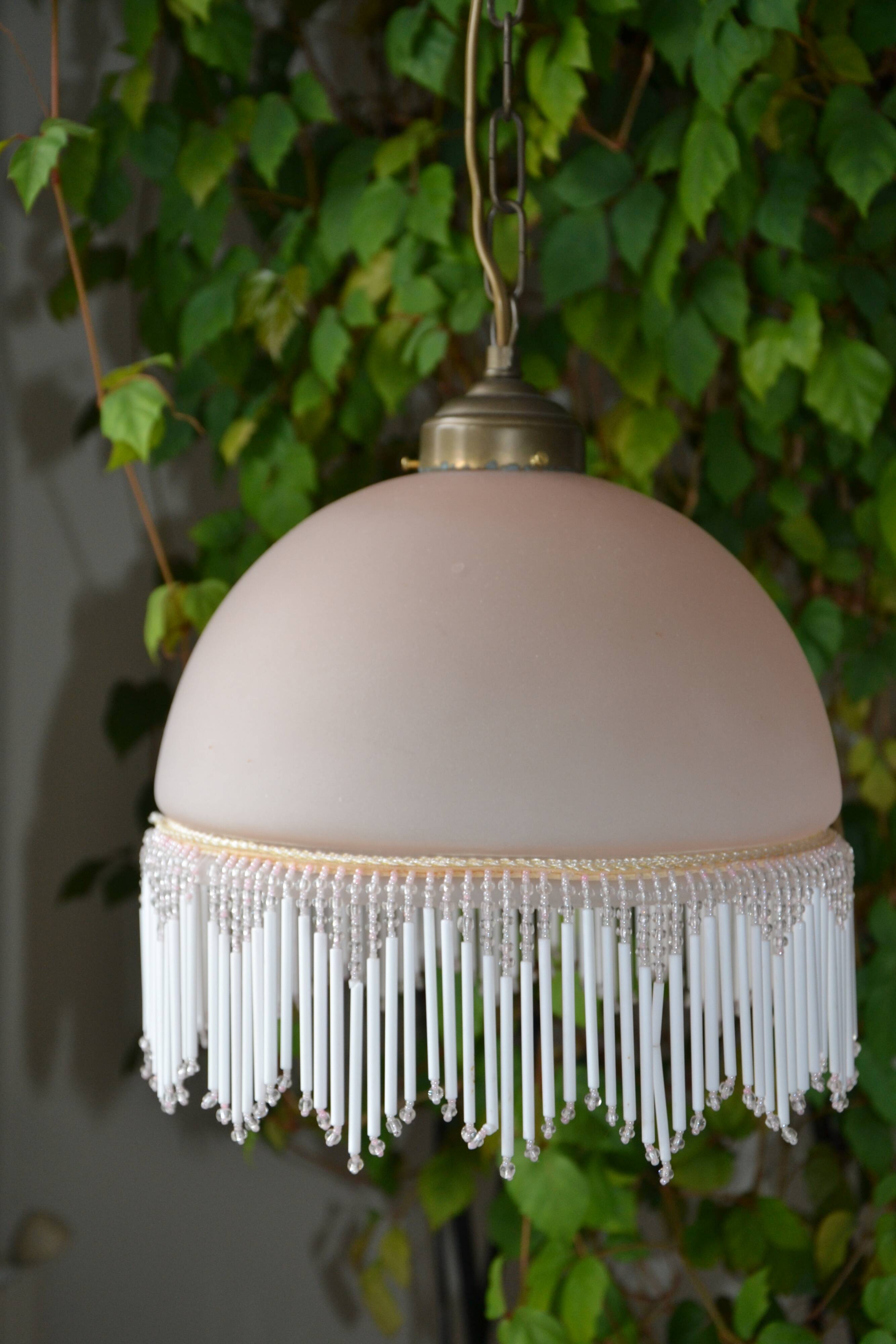Lustrous suspension in glass paste, glass and ceramic pendants.