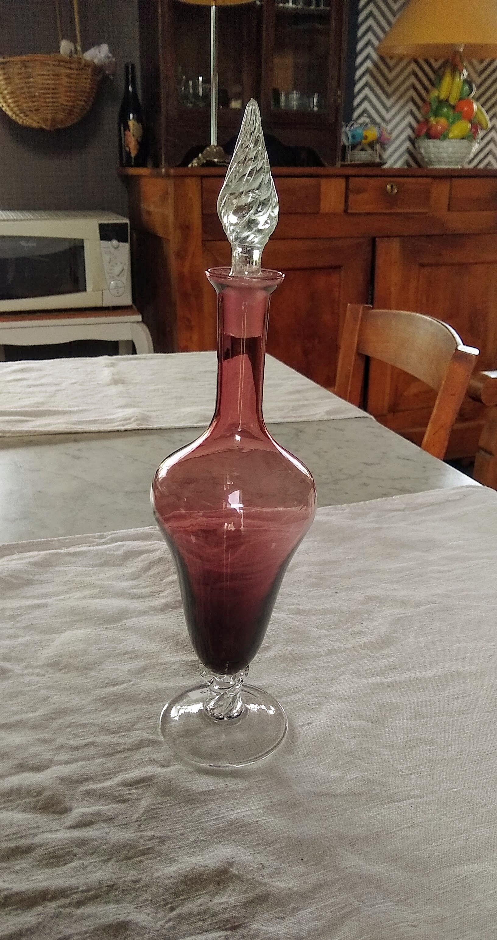 Purple-colored liquor-blown glass decanter with carved foot