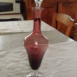 Purple-colored liquor-blown glass decanter with carved foot