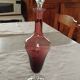 Purple-colored liquor-blown glass decanter with carved foot