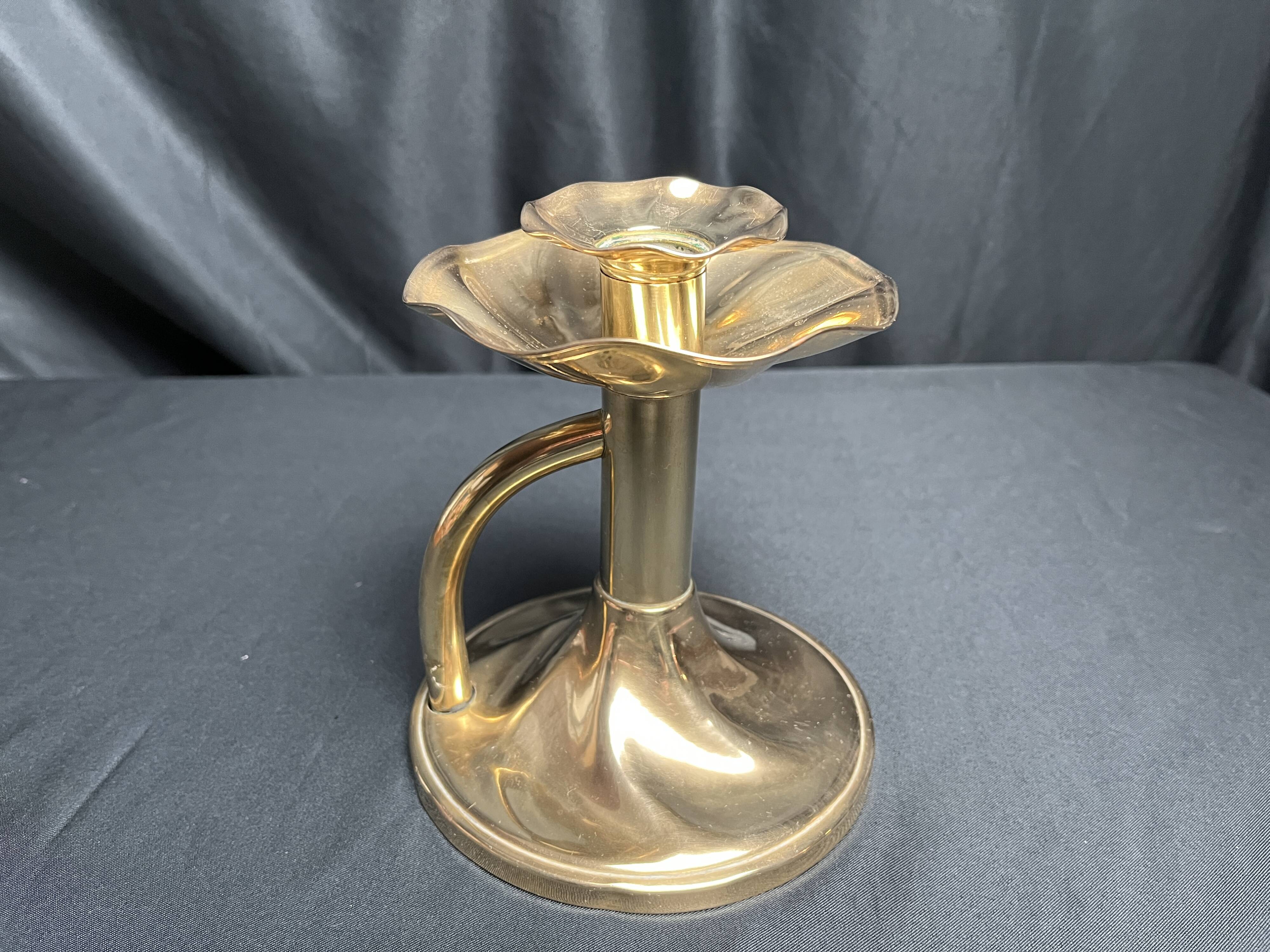 Brass candlestick in a fluted shape from the early 20th century.
