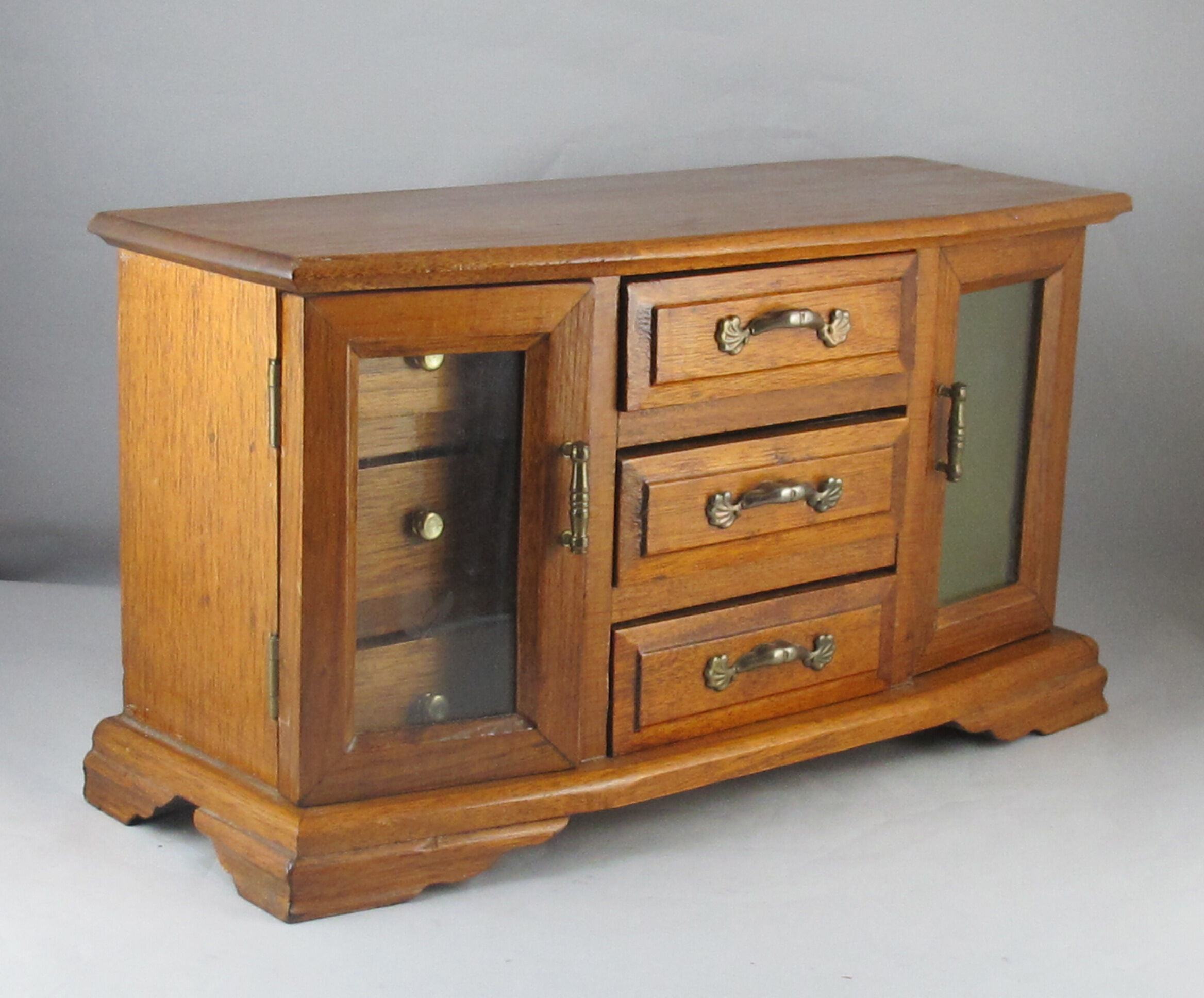 Wooden jewelry box in the shape of a chest of drawers