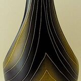 Earthenware vase decorated with yellow lines on a black and yellow background