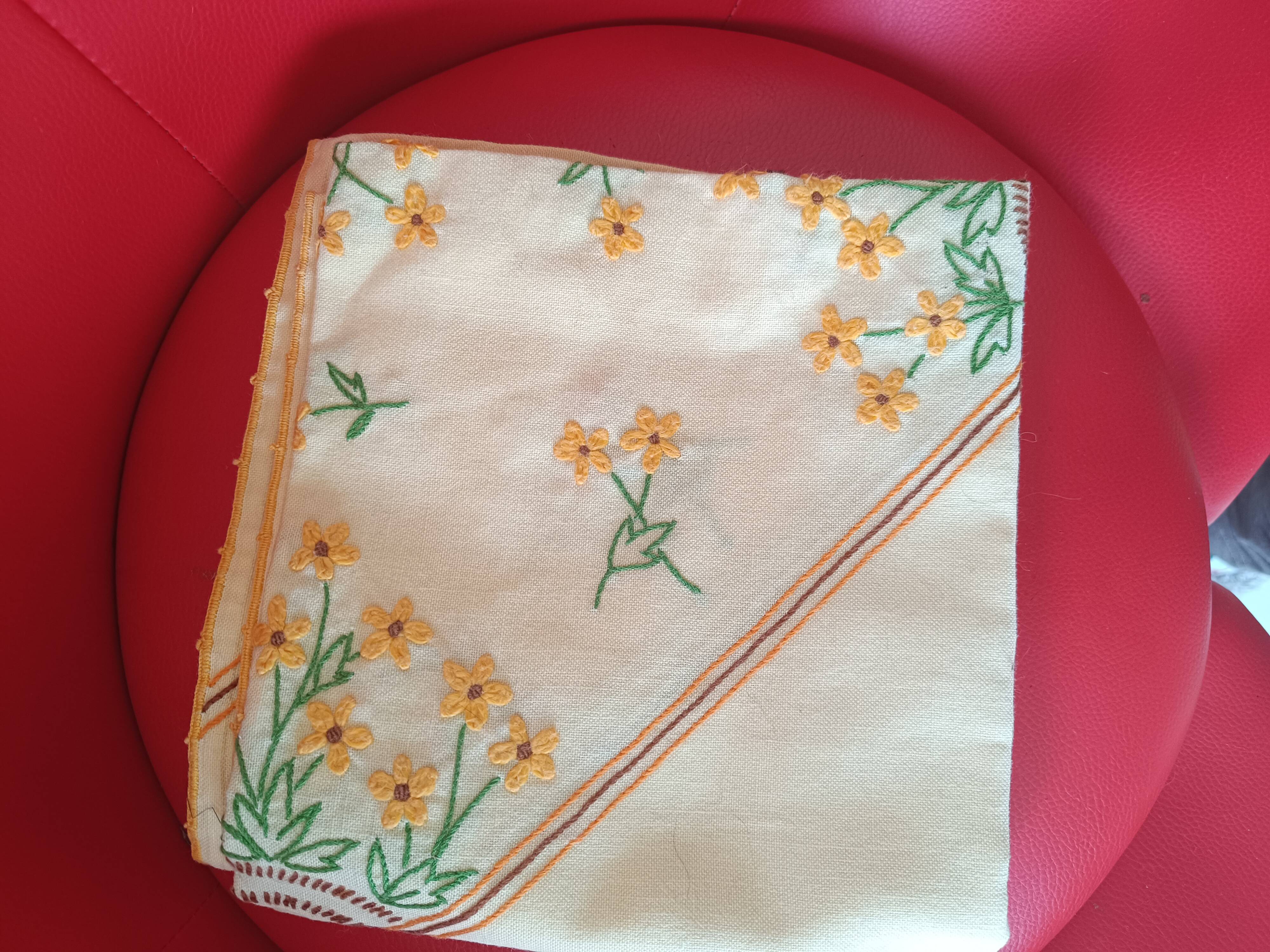 Hand-embroidered yellow square tablecloth.