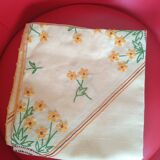 Hand-embroidered yellow square tablecloth.