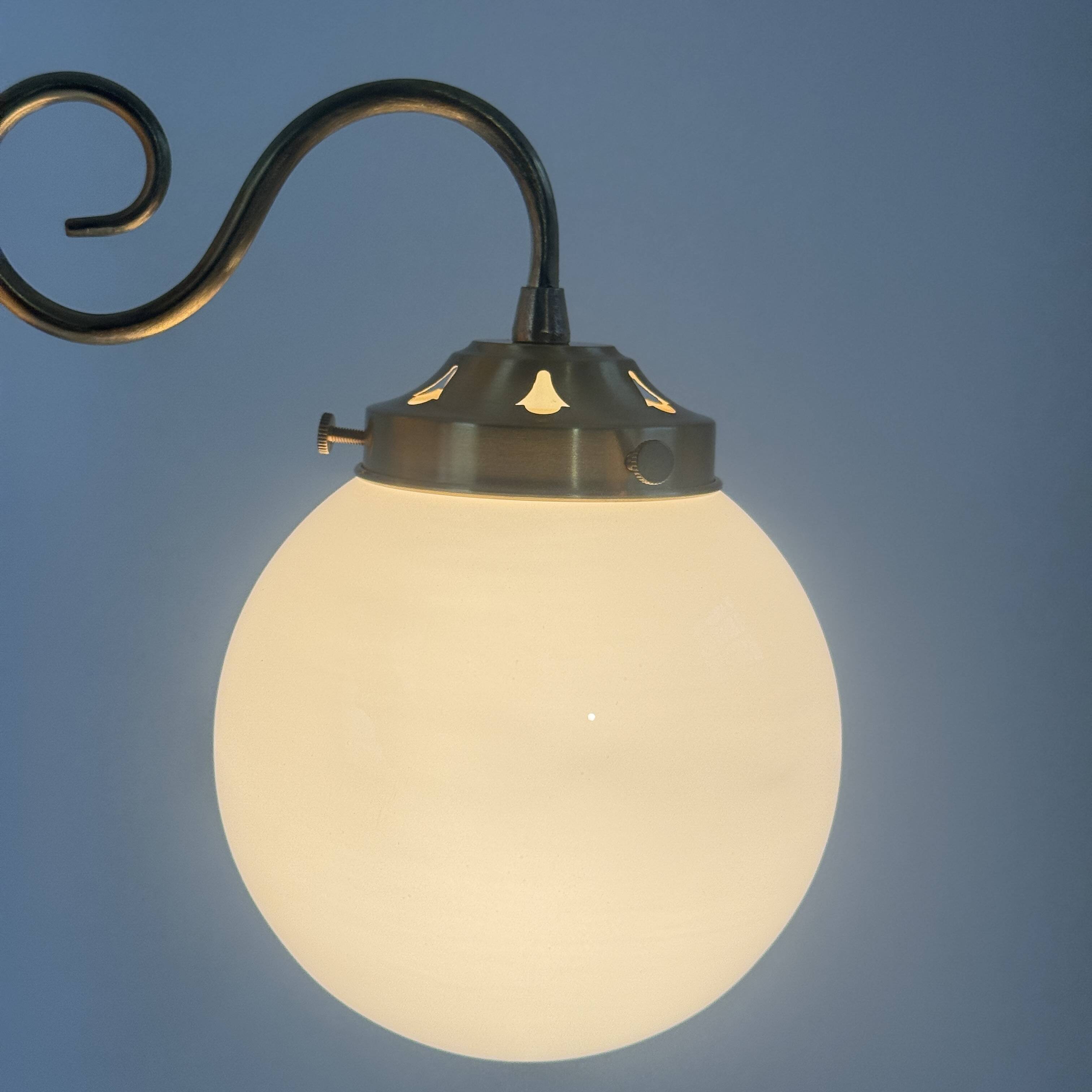 A pair of vintage opaline and brass wall lights