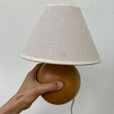 Wooden ball bedside lamp and beige lampshade