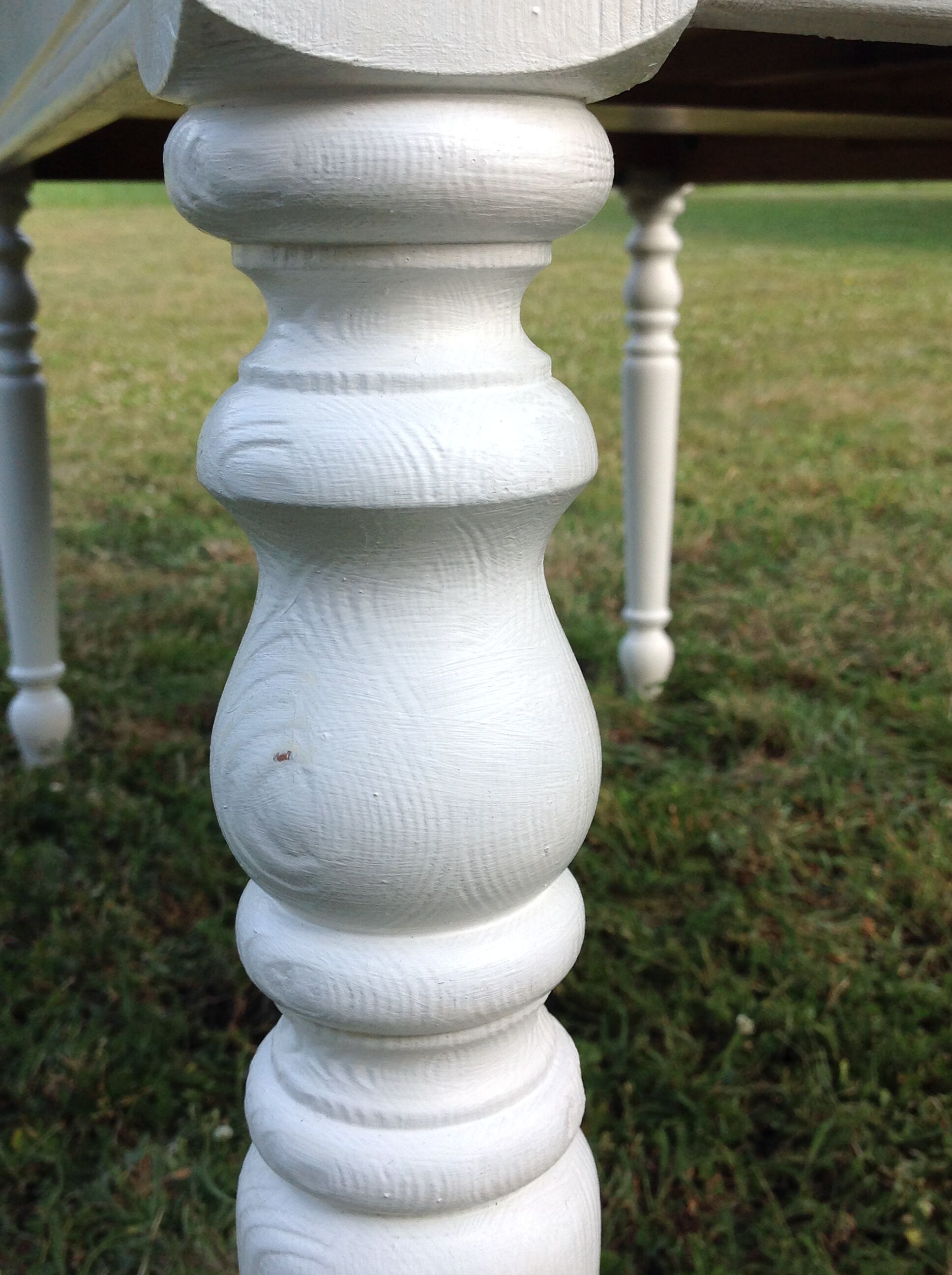 White farmhouse table set and four chairs