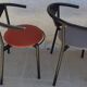 4 gondola-style chairs with a sturdy metal frame and faux leather.