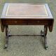 Victorian English extendable coffee table made of solid mahogany and leather.