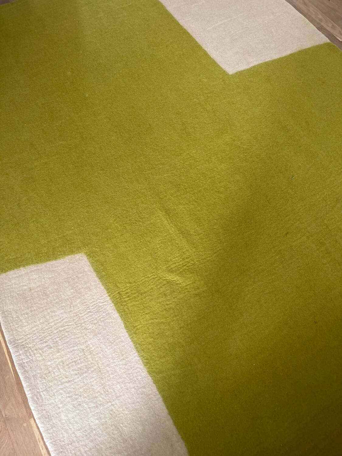 Large felted wool rug from the brand Muskhane, handmade.