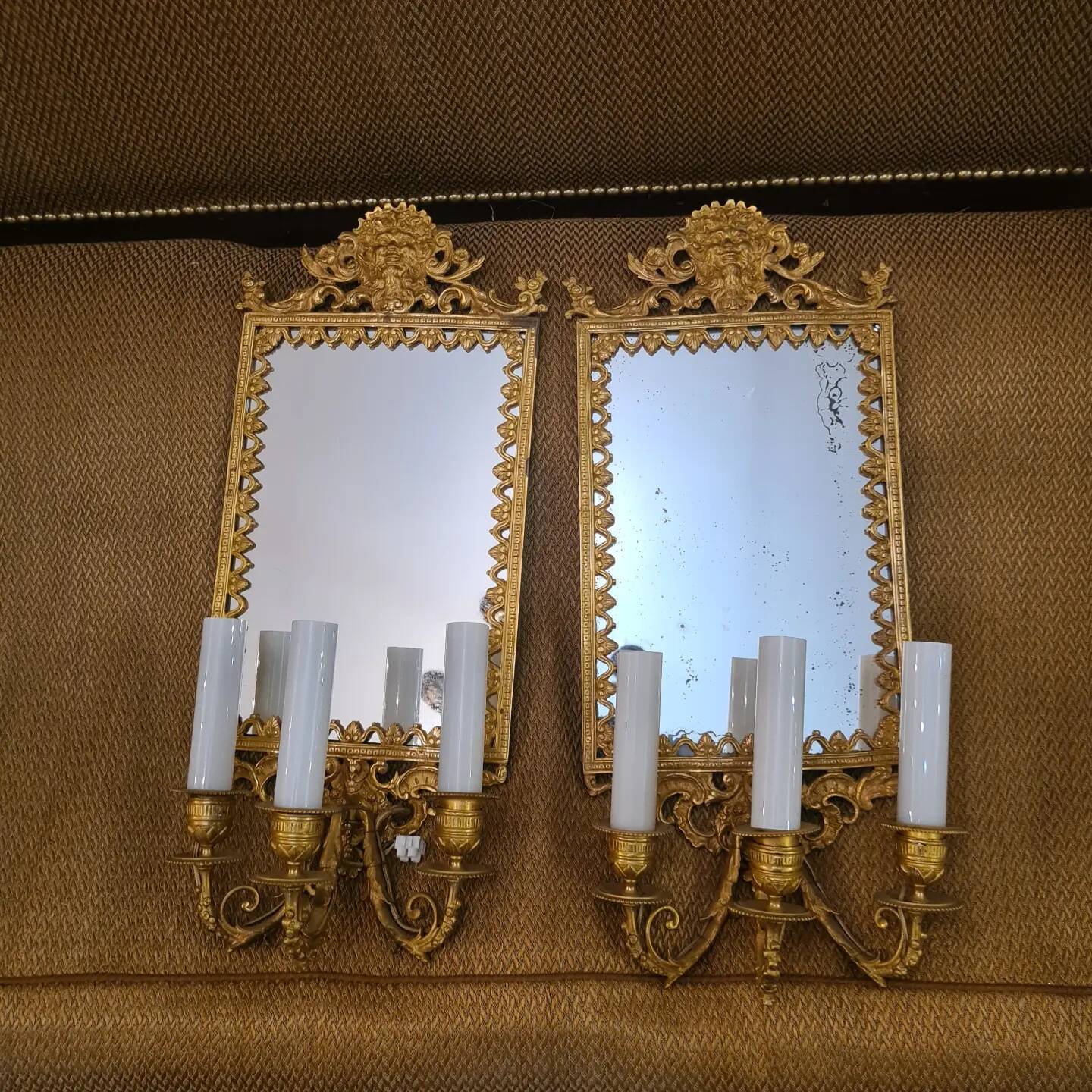 Pair of wall lights with mirror backgrounds with 3 arms of lights in chiseled and gilded bronze. framing decorated with foliage and masks. louis xiv style
