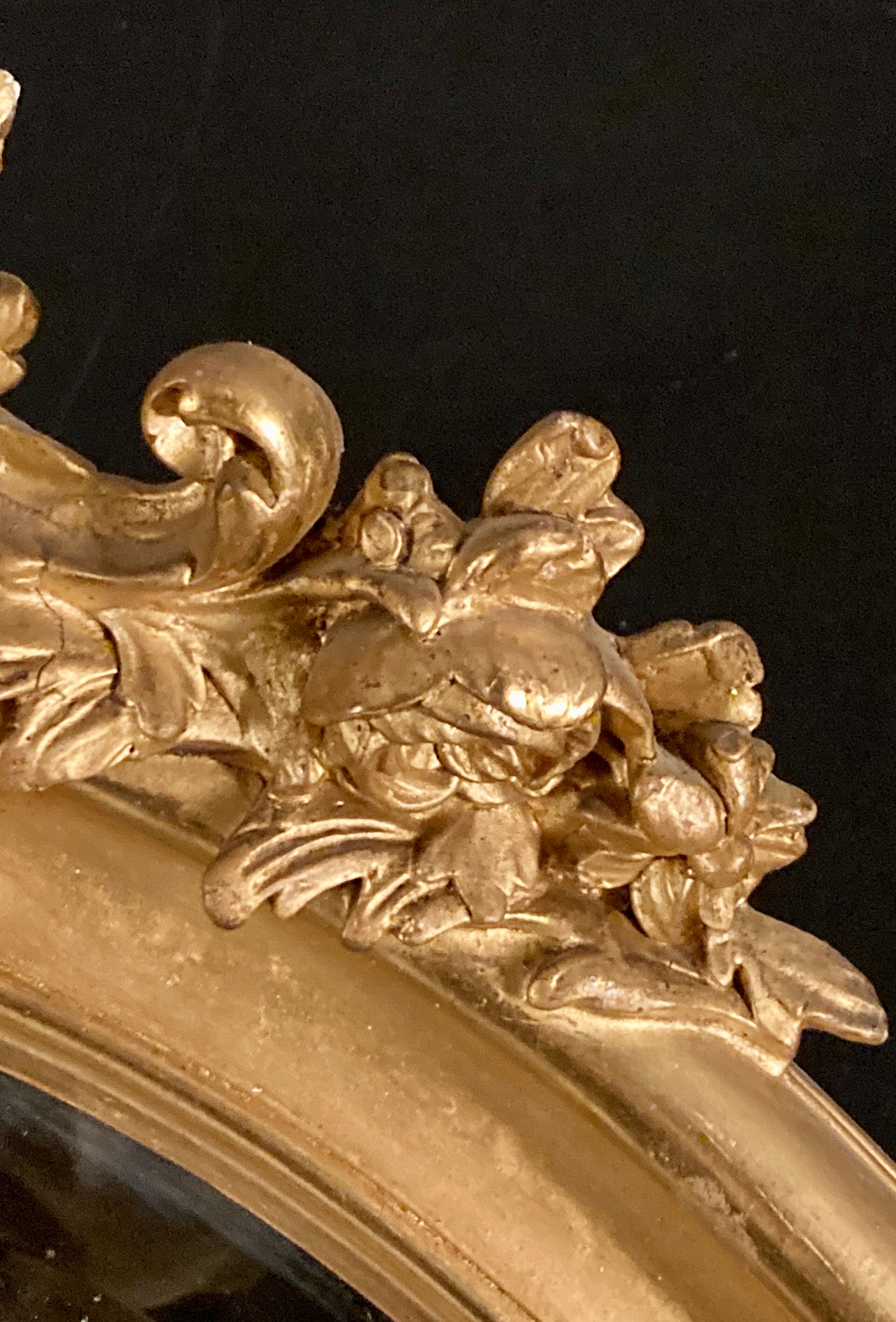 Large oval mirror in gilded wood