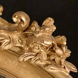 Large oval mirror in gilded wood