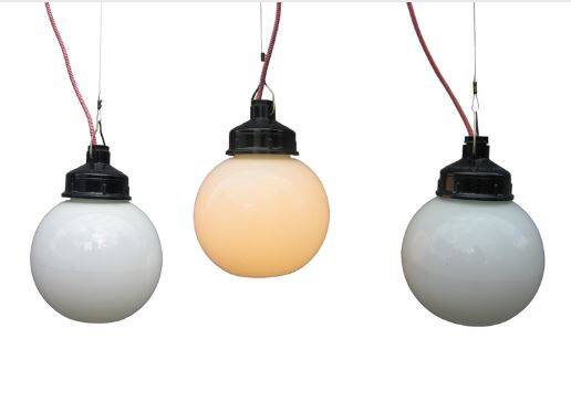 Trio of opal glass and bakelite globe pendant lights