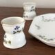Egg cups on a Limoges porcelain tray by Bernardaud with a barbel decoration.