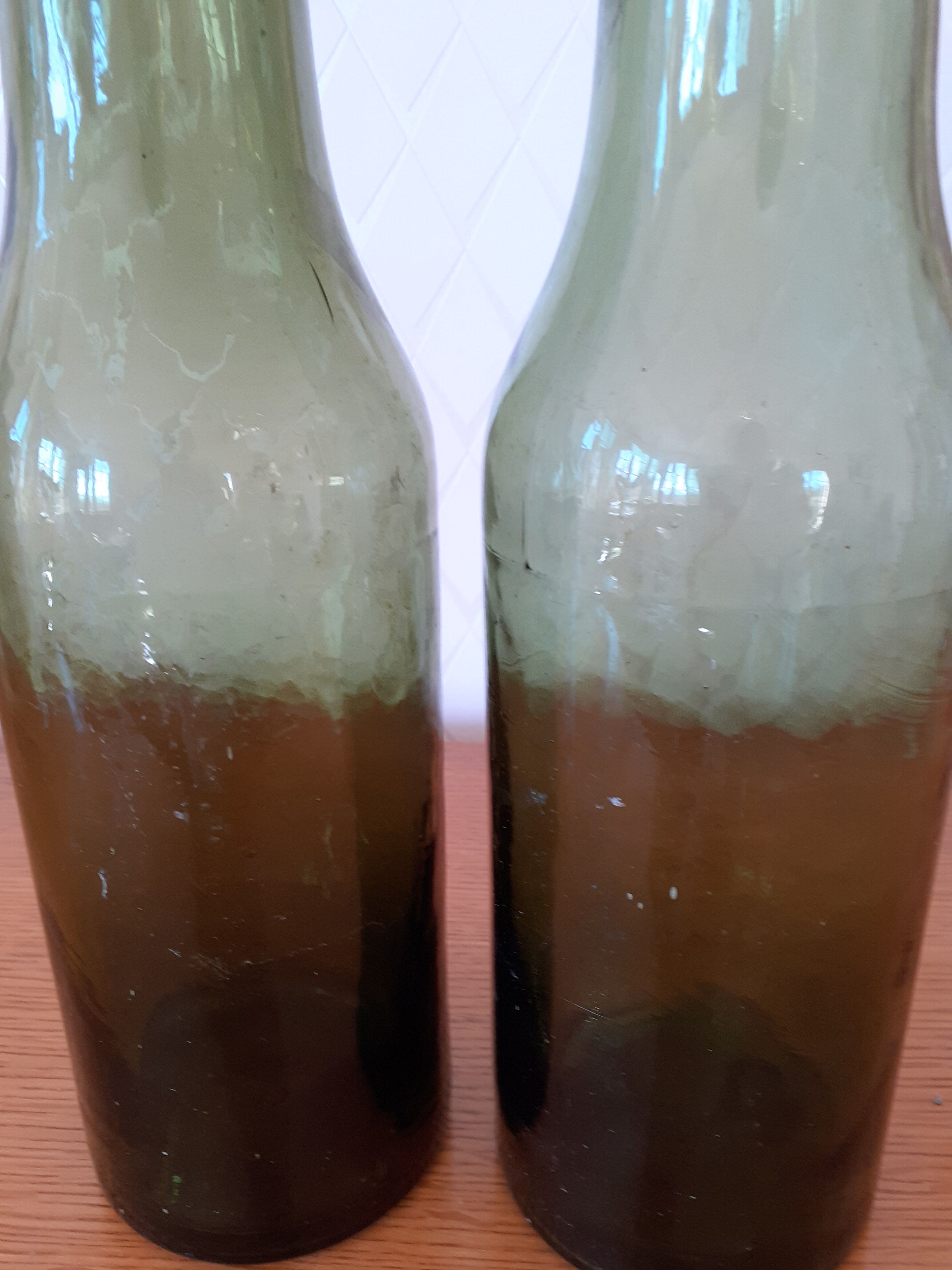 Pair of green bottles made of bubbled blown glass